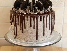 an oreo cookies and cream cake with chocolate drizzles on the top