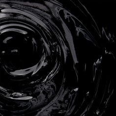 an abstract black and white photo with water swirling around it