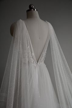 the back of a wedding dress with white sequins