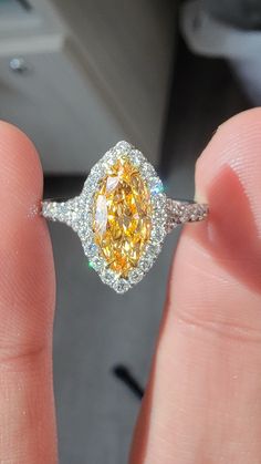 Beautiful Marquise Orange diamond set in a delicate Platinum ring with 0.62ct of rounds The diamond faces up predominantly orange Luxury Yellow Pear-shaped Ring, Elegant Yellow Pear-shaped Diamond Ring, Dazzling Yellow Diamond Ring With Accents, Yellow Platinum Diamond Ring Fine Jewelry, Yellow Platinum Diamond Ring With Diamond Cut, Yellow Diamond Ring With Center Stone, Yellow Diamond Cut Platinum Ring, Yellow Platinum Diamond Ring, Pear-shaped Diamond Ring With Gemstone