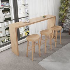 three stools and a table in front of a window with cityscape behind it