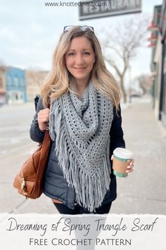 a woman holding a cup of coffee and wearing a scarf with the words dreaming of spring triangle scarf free crochet pattern