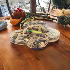 a wooden table topped with lots of different types of items on top of each other