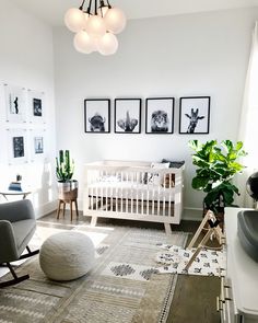 a baby's room with white furniture and pictures on the wall