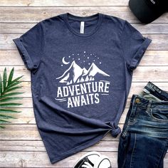 Adventure Awaits T-Shirt, Camping Adventure Travel T-Shirt, Gift for Him Gift for Her, Vacation Shirt, Gift For Traveler, Family Vacation How to Order?  1-Choose your t-shirt color, 2- Choose your size, 3- Select the quantity, 4- Click Add to Cart.  Production and shipping: * 100% airlume combed and ring-spun cotton, 32 singles 4.2 oz. * Solid colors are %100 cotton * Heathers are %52 cotton %48 polyester * Athletic Heather is combed and ring-spun cotton, 10% polyester * Seamless collar * Heat t Graphic Tee With Text Print For Adventure, Adventure T-shirt With Letter Print And Short Sleeves, Adventure Letter Print Short Sleeve T-shirt, Pre-shrunk Crew Neck T-shirt For Adventure, Adventure Graphic Tee With Crew Neck, Graphic Tee Crew Neck For Adventure, Graphic Tee T-shirt With Crew Neck For Adventure, Graphic Tee Crew Neck T-shirt For Adventure, Letter Print Crew Neck Top For Adventure