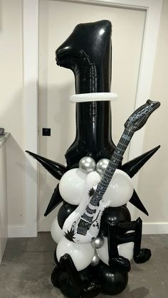 a black and white balloon sculpture with a guitar