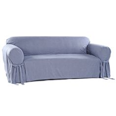 a couch covered in a blue cover with tassels on the arms and legs