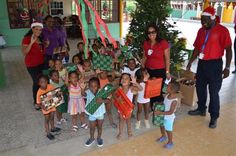 a group of children and adults holding presents