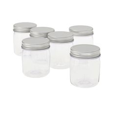 six clear glass jars with silver lids