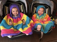 two babies sitting in strollers wearing blankets