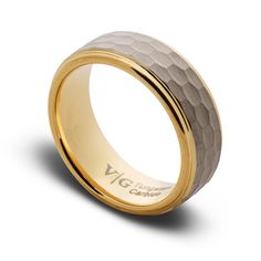 a wedding band with two tone gold inlays and an engraving on the side