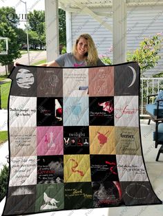 a woman is holding up a quilt on the porch