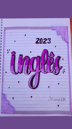 an open notebook with the word inggles written in cursive writing