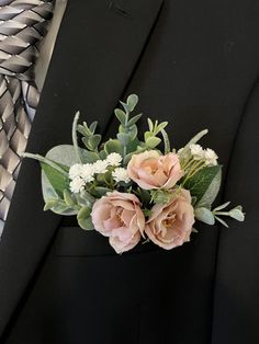 a man wearing a suit and tie with flowers in his lapel flower pinion