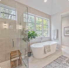 a bathroom with a large tub and shower