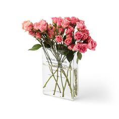 a clear vase filled with pink roses on top of a white table