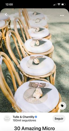 a row of wicker chairs with place settings on them