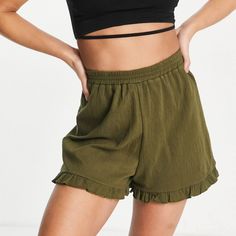 Asos Design Tall Crinkle Short In Cotton With Ruffle Hem Color: Khaki Size: 12 High Rise Elastic Waist No Pockets Ruffle Hem Regular Fit Waist Laying Flat - 15.75” Length - 16.5” Inseam - 3” Stretch, Textured-Woven Fabric 95% Cotton, 4% Polyester, 1% Elastane. Wash With Similar Colors; Do Not Tumble Dry Brand New, Never Worn; Came With No Tags New To Poshmark, Use My Referral Code Momgar22 For $10 Off Your First Purchase When You Set Up A New Poshmark Account. T6 Casual Green Shorts With Ruffles, Casual Green Ruffled Shorts, Casual Relaxed Fit Ruffled Shorts, Color Khaki, Ruffle Hem, Woven Fabric, Elastic Waist, Asos, High Rise