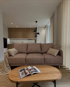 a living room with a couch, coffee table and television in the corner next to it