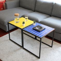 a couch and table in a room with a rug on the floor next to it