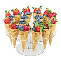 several cones with strawberries and blueberries in them