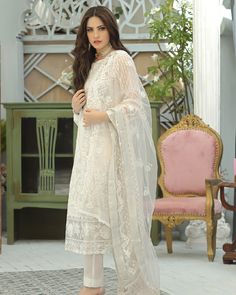 Pakistani Salwar Kameez Heavily Embellished Ivory Salwar Suit Dupatta comes with detailed florals bloom in moonlit tendrils on the dreamy ivory organza canvas. luxuriously laden with iridescent sequin, sparkling crystal Color thread creating an ethereal impact. Paired with a diaphanous net dupatta emblazoned with filigreed bootis, elaborately detailed borders and dramatically accented pants. Ivory Kameez: The kameez is emblazoned with lavish designs, embroidery, and floral designs. The fabric of Salwar Kamiz, Pakistani Salwar Kameez, Organza Dupatta, Net Dupatta, Georgette Fabric, Salwar Suit, Fabric Stores Online, Embellished Dress, Designer Suits