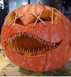 a carved pumpkin with teeth and fangs on it