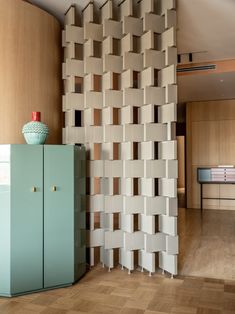 a room with wooden flooring and a wall made out of cubes on the walls