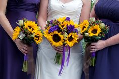 the bridesmaids are holding sunflowers and purple bouquets in their hands