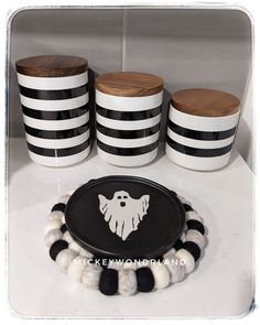 some black and white striped cups are sitting on a table