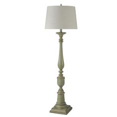 a lamp that is on top of a stand with a white shade over the base