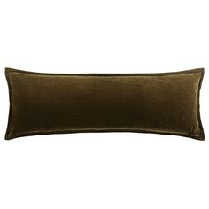 a dark green velvet pillow on a white background