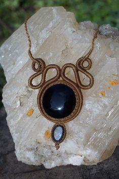 This necklace is made with our hands with the macramé technique using very durable waxed thread. We have set a black Obsidian from Mexico, specifically purchased in Teotihuacán, through a family and fair trade. The design also contains a rainbow Moonstone to give light to the jewel and enjoy its unique properties. Each necklace is complemented with a personally written micro story, based on a poetic interpretation of the properties of the stones with which we try to connect with the person who w Black Macrame Jewelry For Festivals, Bohemian Black Macrame Necklace, Black Wire Wrapped Jewelry For Festival, Bohemian Black Wire Wrapped Crystal Necklaces, Black Bohemian Crystal Necklace Wire Wrapped, Bohemian Black Wire Wrapped Crystal Necklace, Handmade Obsidian Necklaces As Gift, Bohemian Black Wire Wrapped Necklace, Black Adjustable Mystical Necklace