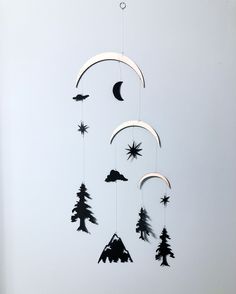 a wind chime hanging from the ceiling with stars and crescents on it's sides