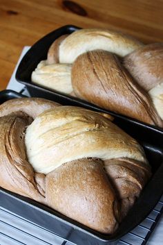 two loafs of bread sitting on top of a pan