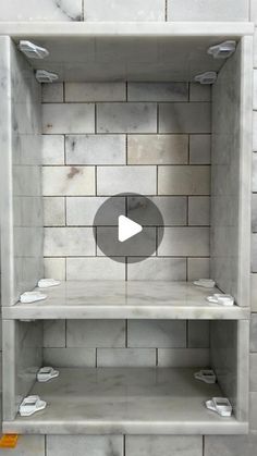 an empty shelf in the middle of a tiled wall