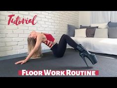 a woman in red shirt and black leggings doing a yoga pose on carpet