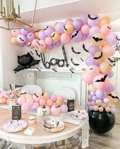 a table topped with lots of balloons and bats