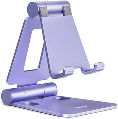 a purple cell phone holder is on top of a laptop computer stand with the lid open