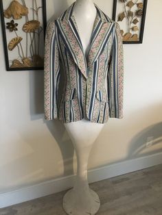 "Nice blazer by F.A. Chatta LTD. Features dutch blue stripes and pink floral stripes...very unique. Big lapel and one button closure at waist area. Front pockets are fake. Has a satiny feel to it, but I'm pretty sure i'ts a blend of some type. Just back from dry cleaner, which tag recommends. Only issue to note, there's a dull brown line near sleeve hem...I think the dry cleaner pressed the sleeve hem wrong, they pressed down the original old hemline. Measurements: 37\" chest; 32\" mid body; 38\ Elegant Multicolor Blazer With Notch Lapel, Fitted Floral Print Blazer With Notch Lapel, Chic Fitted Blazer With Floral Print, Fitted Multicolor Single Breasted Blazer, Fitted Multicolor Single-breasted Blazer, Retro Spring Blazer With Lapel Collar, Multicolor Fitted Notch Lapel Blazer, Retro Lapel Collar Blazer For Spring, Spring Fitted Blazer