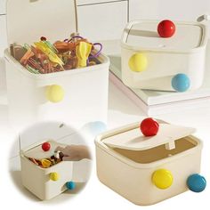 two white storage containers with colorful balls on the lids and handles, one is filled with food