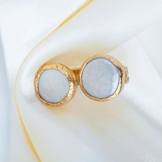 Embellished with mother of pearls, ISRA ring depicts a unique blend of bold and chic. This intricate ring is handcrafted in bronze; plated in 18K gold. SPECS: ◆ Material: 18k gold plated, bronze ◆ Fit: Adjustable WHAT WOULD YOU GET? 1x 18k Gold Plated ISRA Ring Our best seller: https://www.etsy.com/listing/1527019575/ CARE INSTRUCTIONS: * To keep your solid ring in great condition, avoid exposing it to harsh chemicals, excessive sunlight, or moisture. * Gently wipe it with a soft cloth after eac Elegant Gold Rings With Mother Of Pearl, Formal Mother Of Pearl Round Ring, Formal Round Mother Of Pearl Ring, Formal Mother Of Pearl Ring, Elegant Round Mother Of Pearl Ring, Wedding Pearl Ring In Mother Of Pearl, Wedding Pearl Ring With Mother Of Pearl, Gold Mother Of Pearl Rings For Anniversary, Gold Mother Of Pearl Anniversary Rings