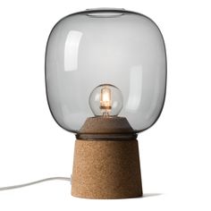 a light that is sitting on top of a cork table lamp with a glass bulb