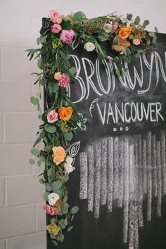 a chalkboard sign with flowers and greenery on it that says brown's vancouver