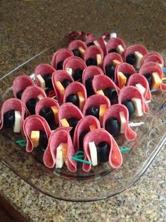 an assortment of appetizers are arranged in the shape of flowers on a platter