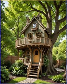 a tree house in the middle of a lush green yard with stairs leading up to it