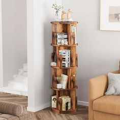 a living room filled with furniture and a tall wooden shelf next to a couch in front of a wall