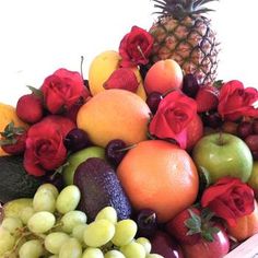 a pile of fruit with roses and apples