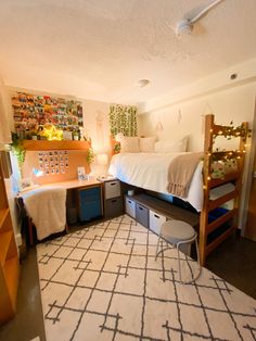 a bedroom with bunk beds and desks in it