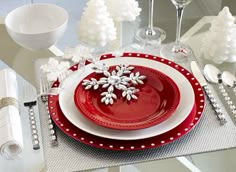 a red and white place setting with snowflakes